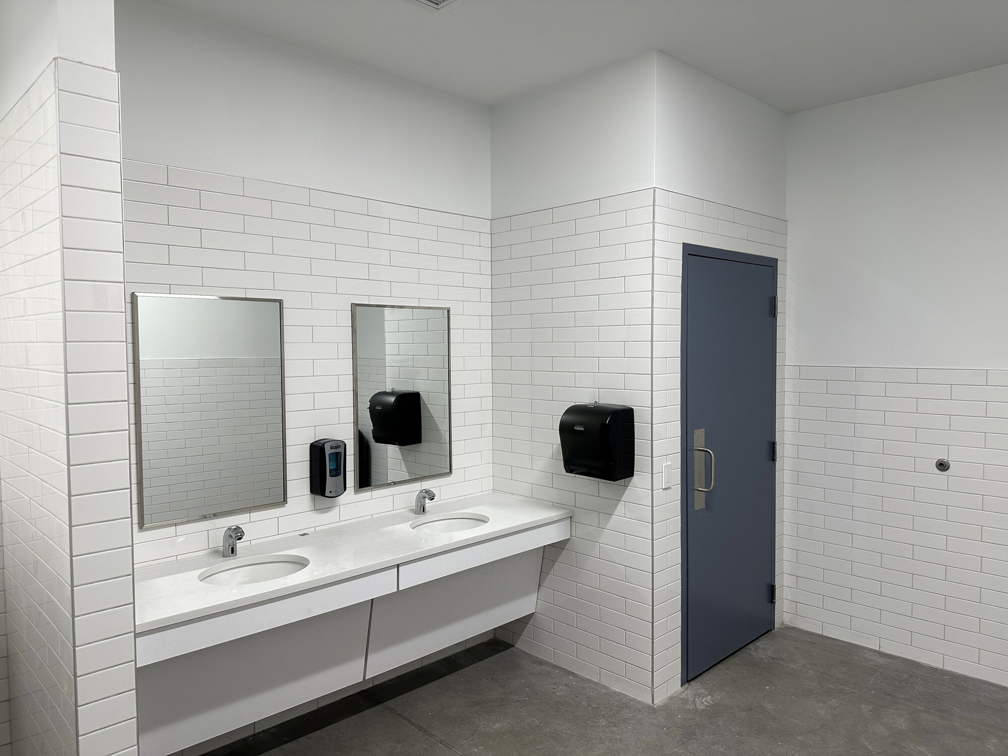 Restroom with double vanity and subway tile