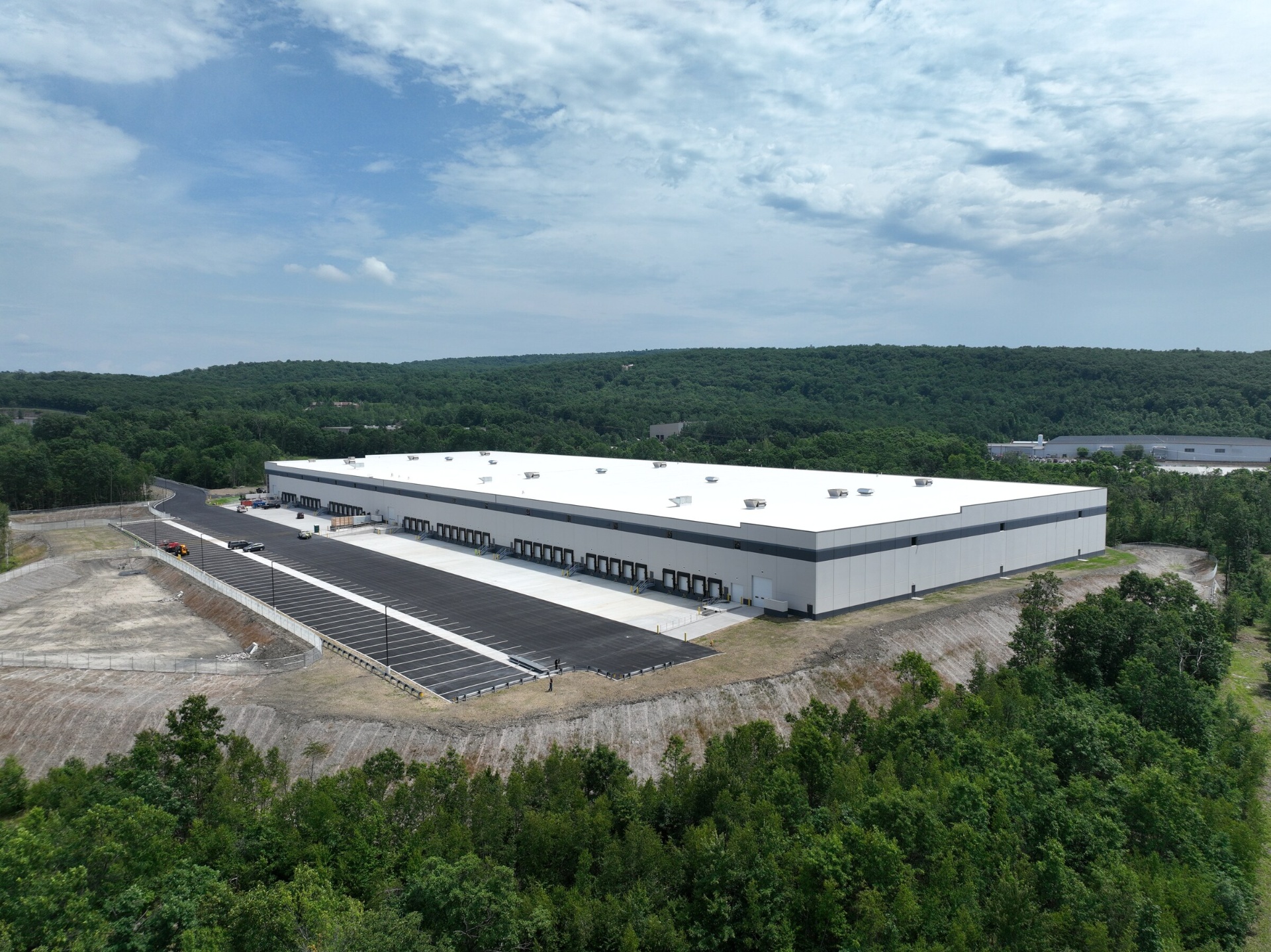 Aerial view of the completed building and full truck court